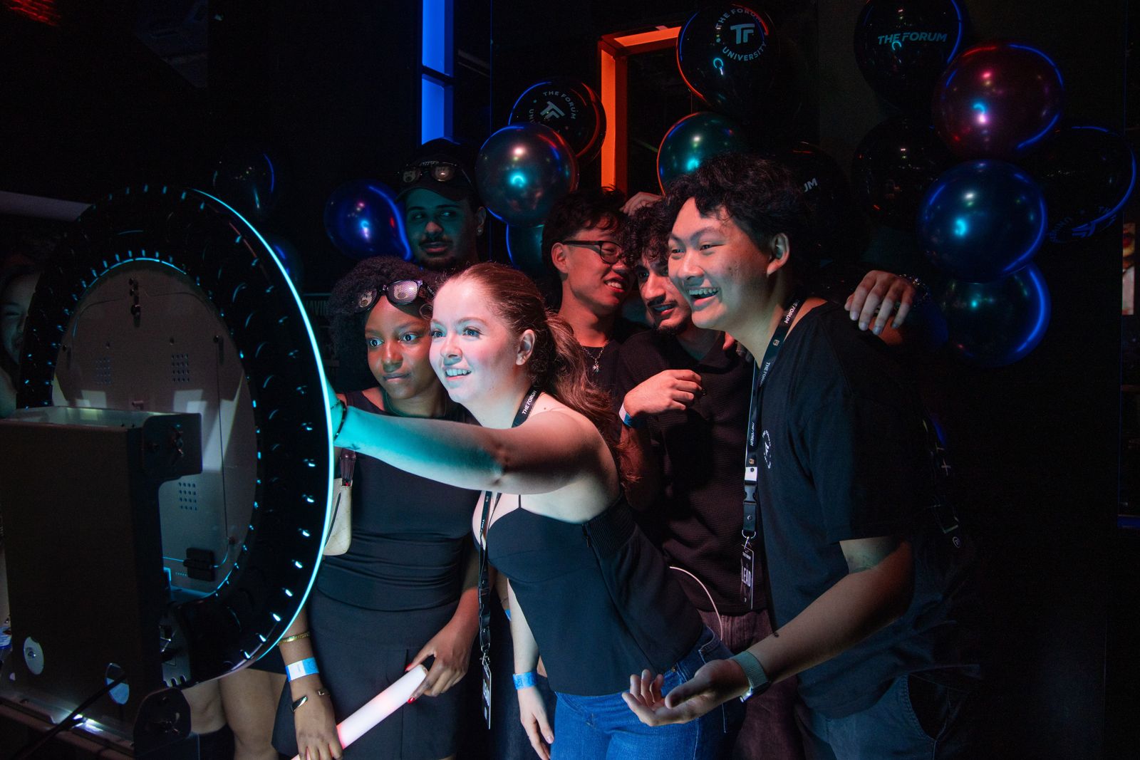 Guests crowding in front of the Pacific Photobooth ring light at Rewind, SFU's back to school party