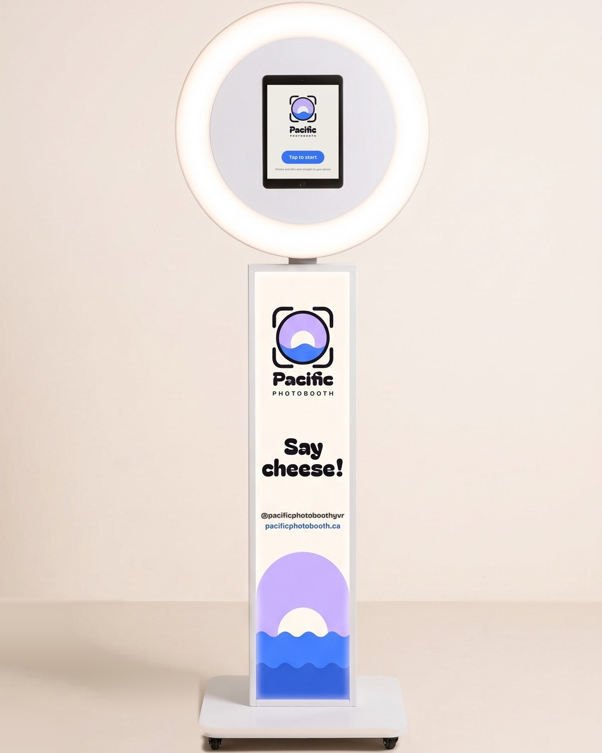 The Pacific Photobooth Classic booth: ring light with an iPad showing Tap to start, above the lit column wrap