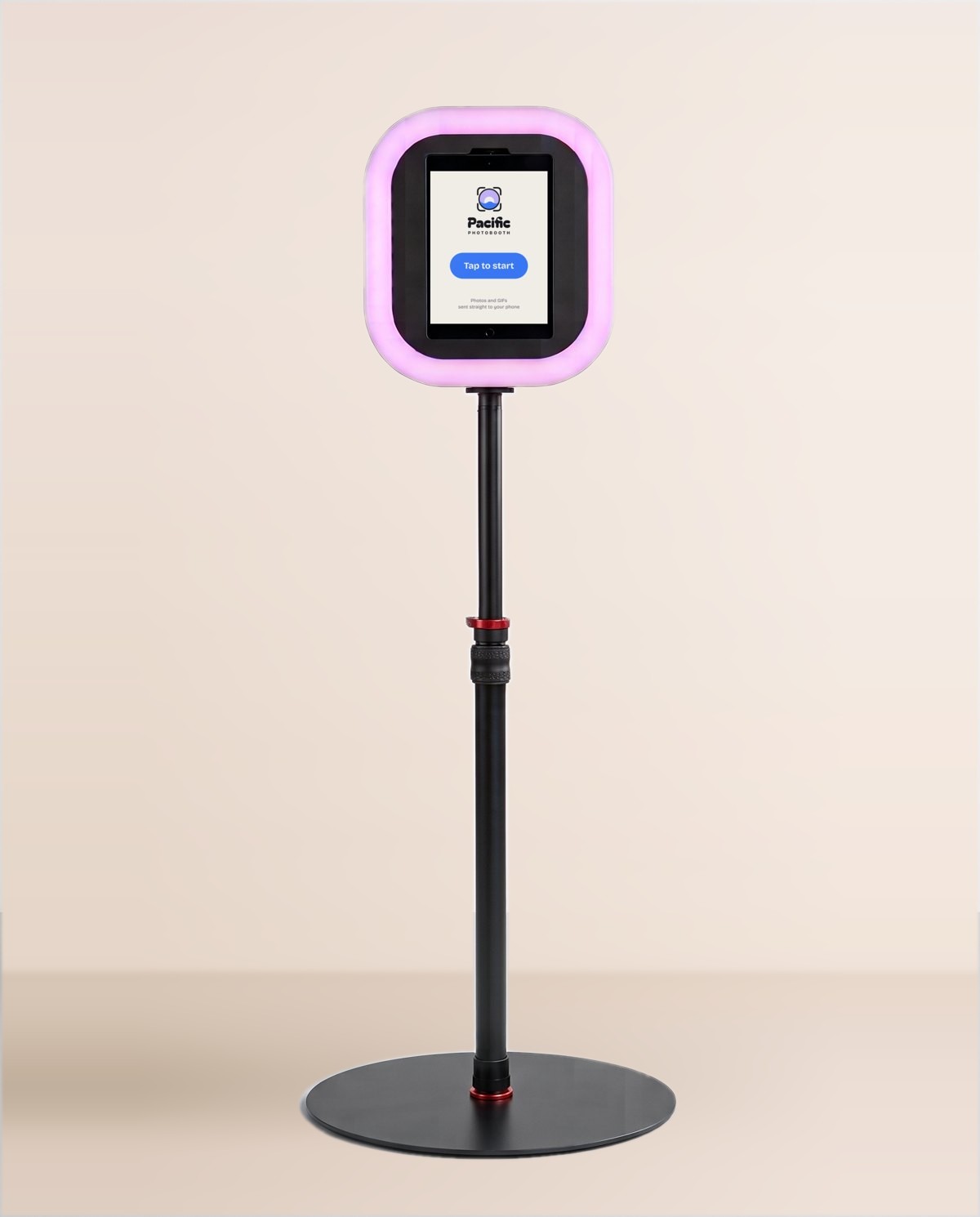 The DIY photobooth: an iPad showing the Pacific Photobooth Tap to start screen, in a glowing ring light on a stand